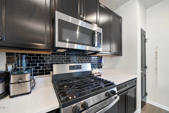 Updated 2023 kitchen with sleek cabinets and quartz counters