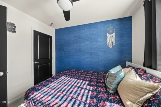 Primary bedroom with large windows and spacious layout