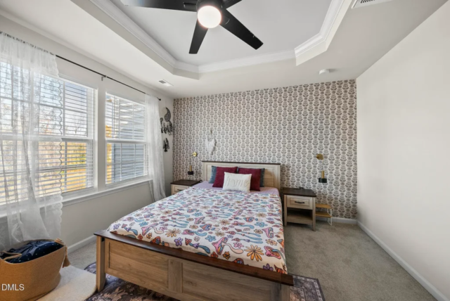 Primary bedroom with large windows and spacious layout