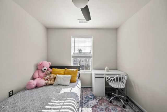 Primary bedroom with large windows and spacious layout
