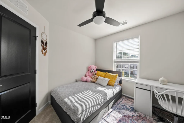 Primary bedroom with large windows and spacious layout